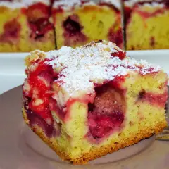 Pyszne ciasto ucierane z truskawkami z olejem, posypane cukrem pudrem. Idealne na deser.