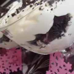 Pyszne deserki z kremem i pokruszonymi oreo ciastkami w szklanych pucharkach.